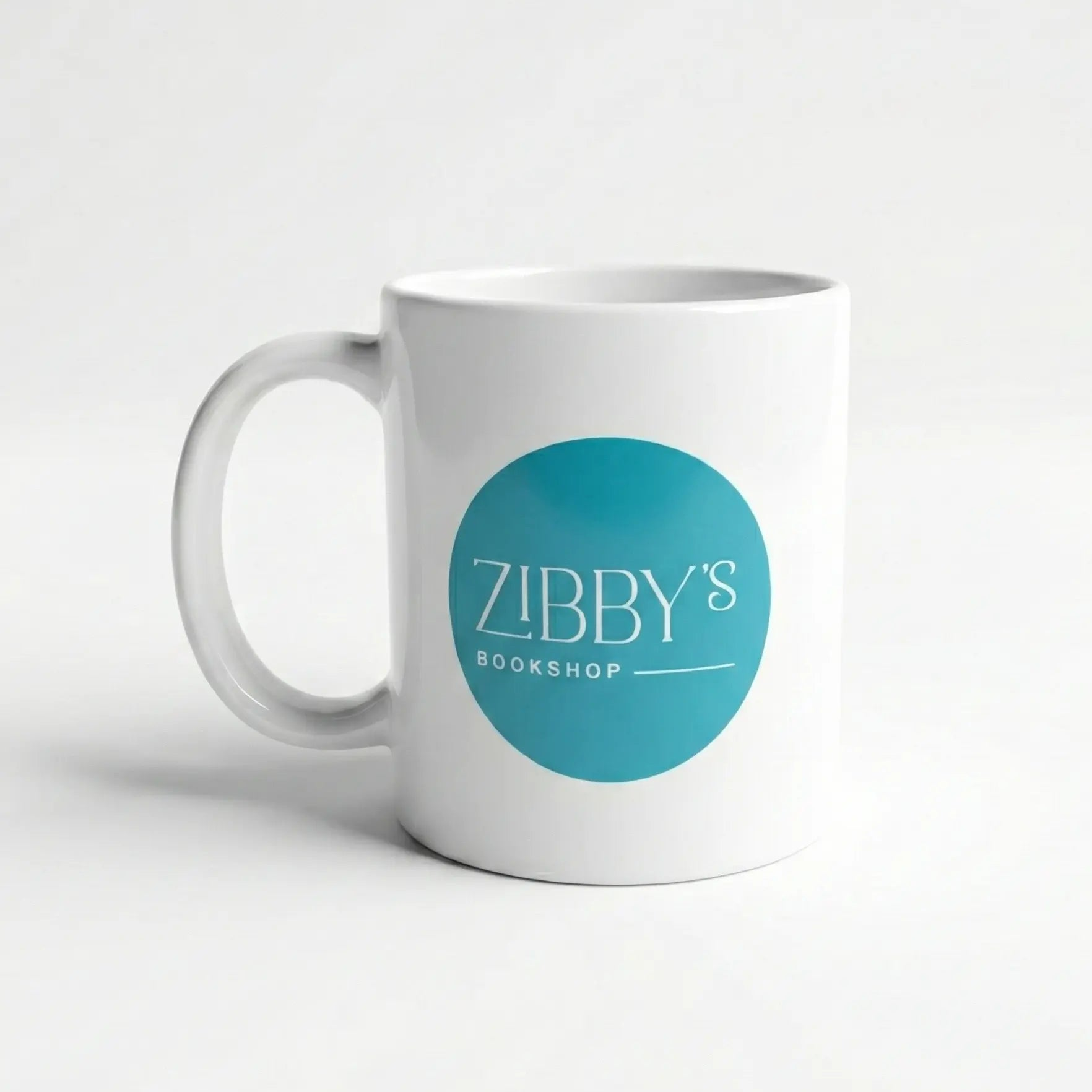 White mug with a blue circular logo featuring 'Zibby's Bookshop' on a white background