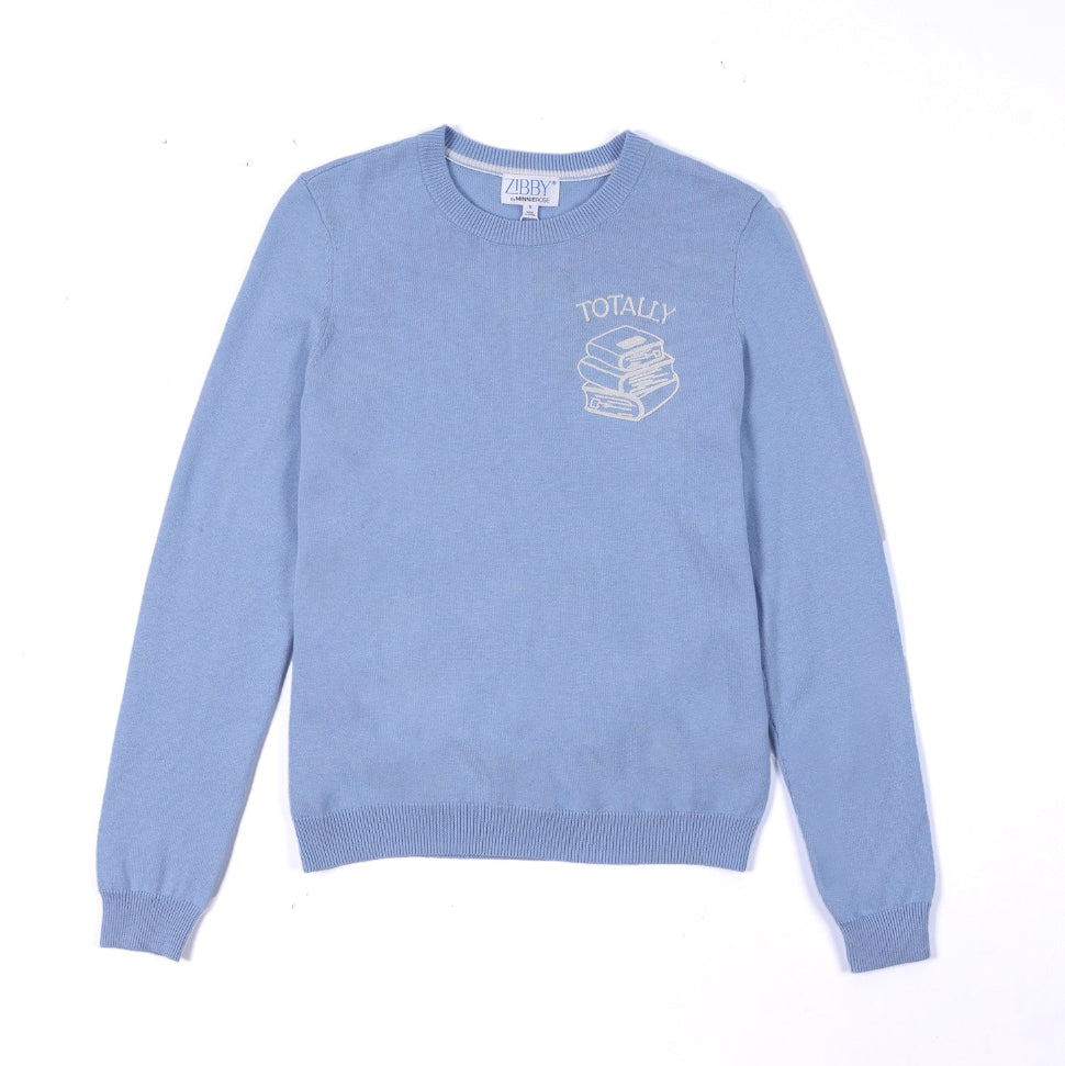 Light blue sweater with a graphic design on a black background